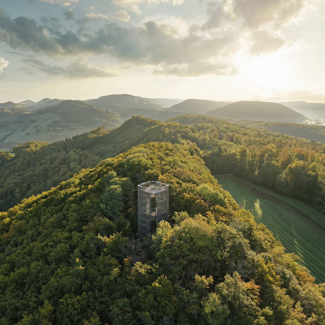 View of the Cheisacher tower in the middle of a forest landscape in the Argovia Jurapark.