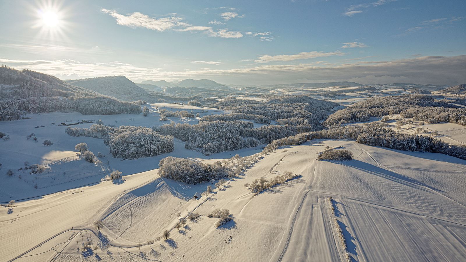 Paesaggio innevato con colline boscose