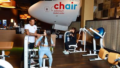Aircraft cockpit and training staff in the fitness room at Airport Fitness and Wellness at Zurich Airport.