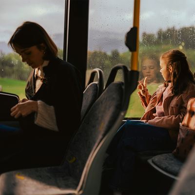 A passenger holding on to a yellow handrail