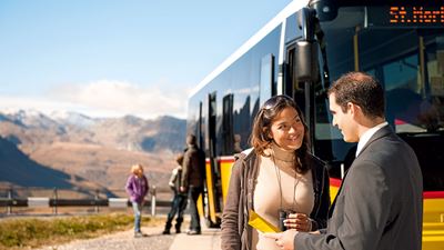 A bus driver talking to a woman