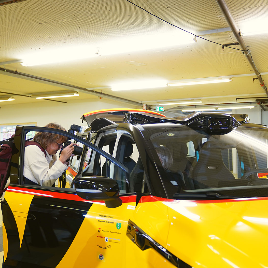A photographer takes a photo of an AmiGo vehicle