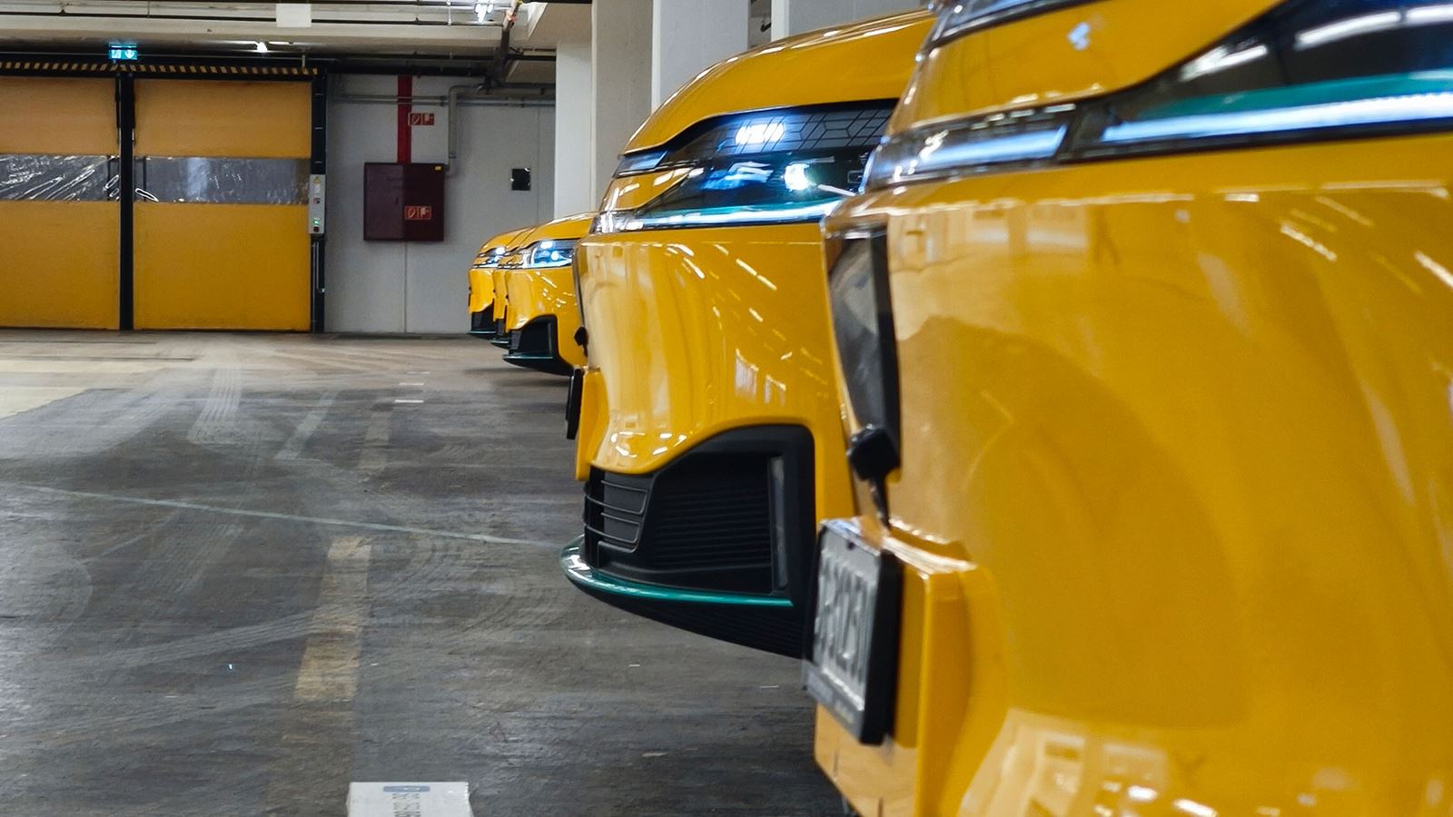 Yellow AmiGo vehicles parked in a row
