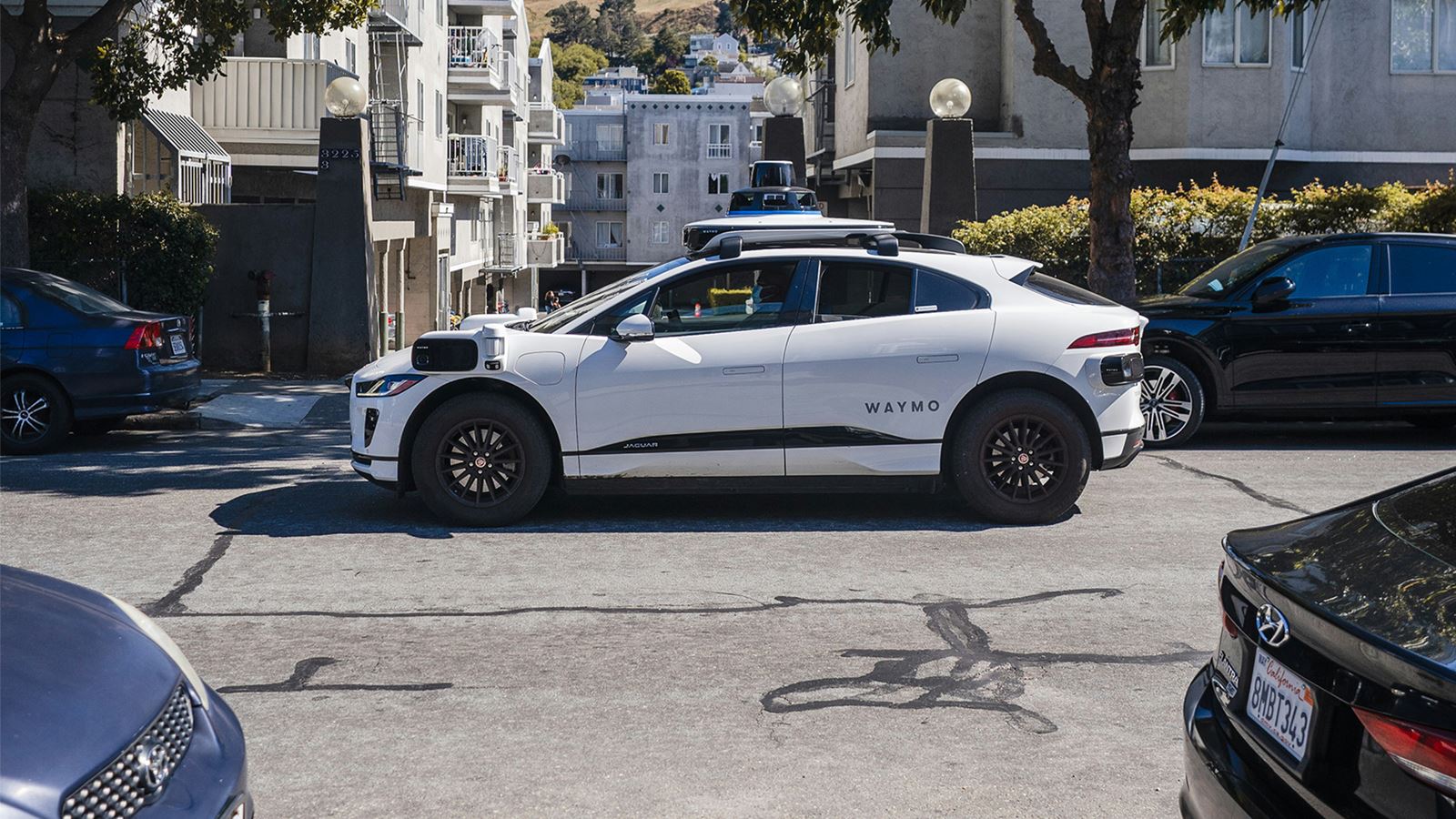 Waymo’s autonomous vehicle driving through a residential area in the USA